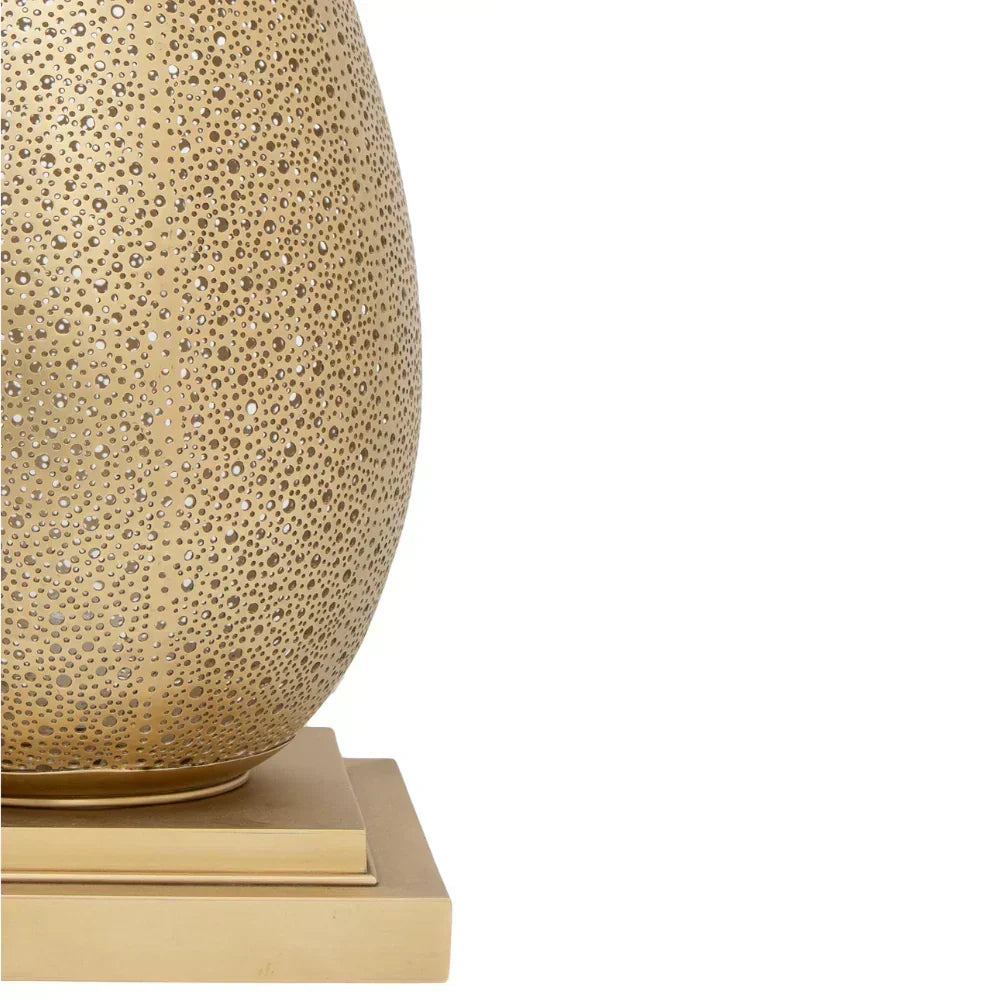 Decorative lamp with textured surface and base on a white background