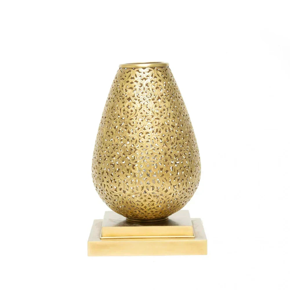 Decorative gold vase with intricate patterns on a white background