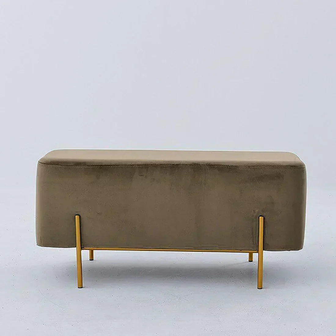 Beige upholstered bench with gold legs on a light gray background