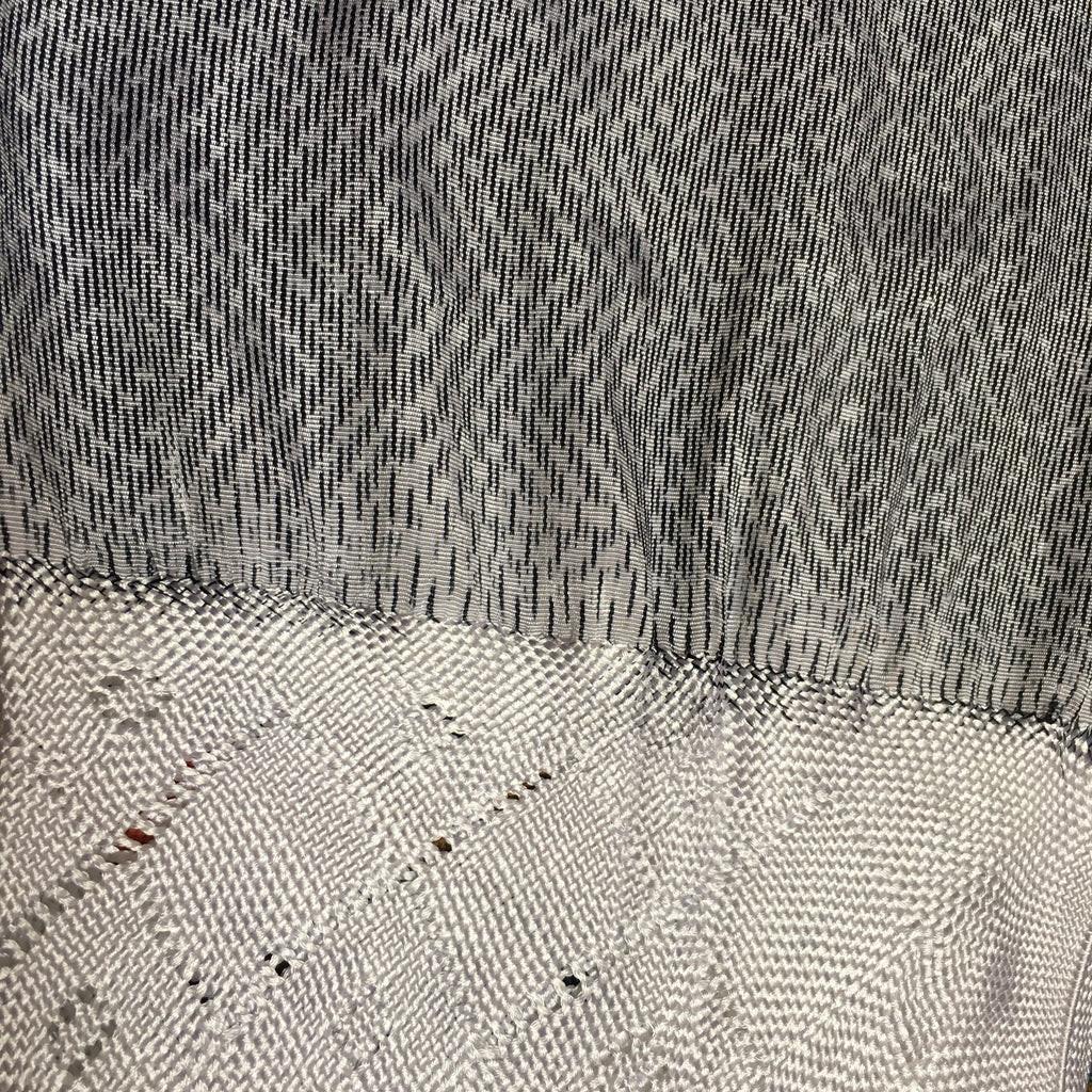 Close-up of textured fabric with a patterned design White Black