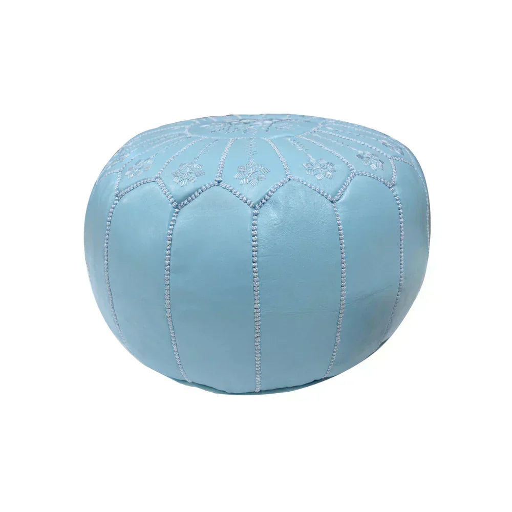 Blue ottoman with embroidered patterns on a white background