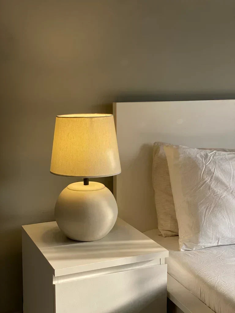 “MELLOW’ lamp with matte-finished terracotta base and black accents, paired with a cream shade – 18-inch handcrafted ceramic lighting.”