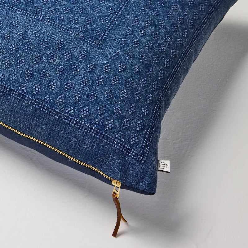 Blue textured pillow on a light gray background Navy