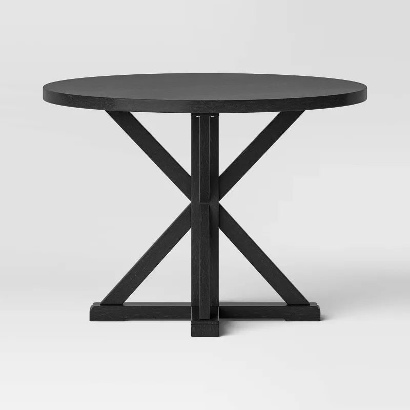 Black round table with a X-shaped base on a white background