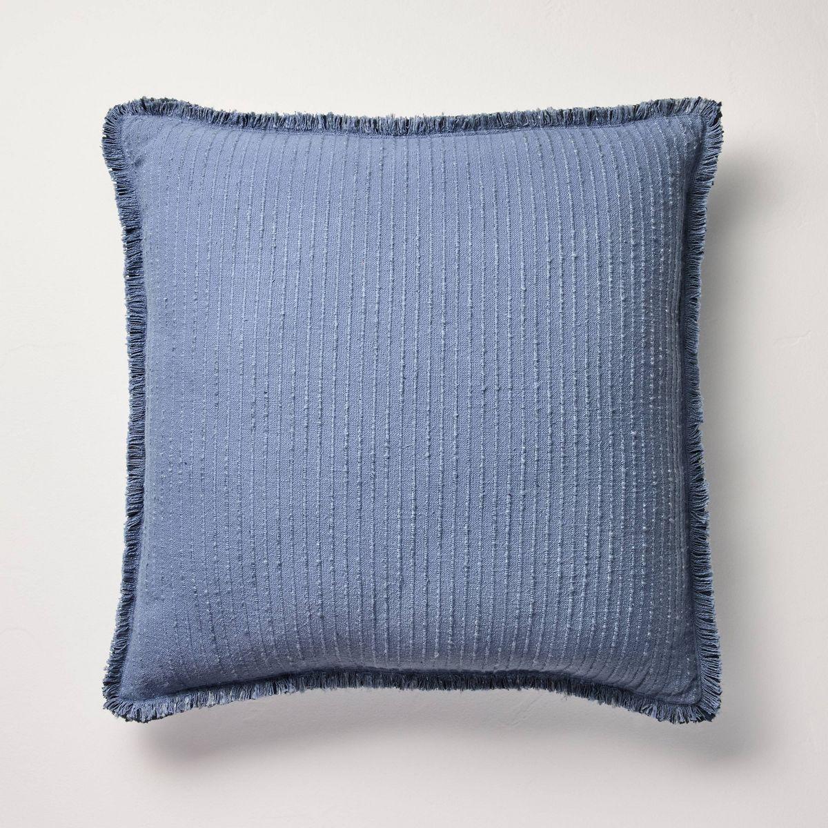 Blue textured blanket with frayed edges on a gray background Navy
