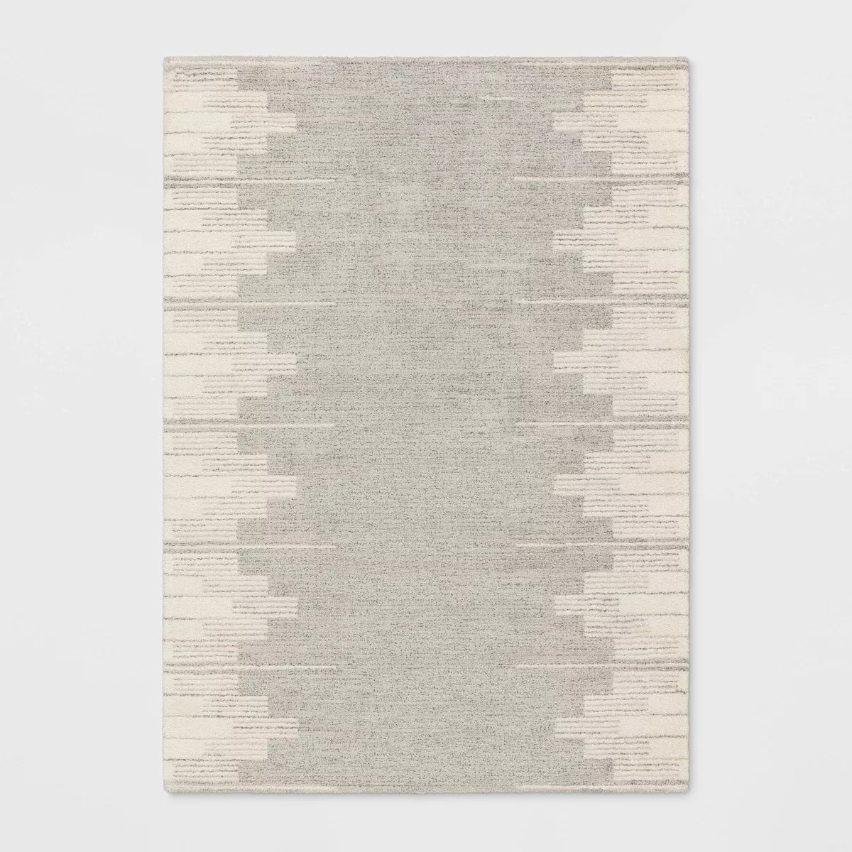 Gray and beige patterned rug on a light gray background