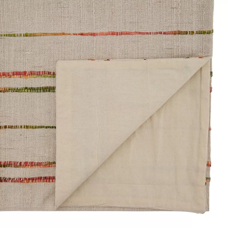 Textile with a folded corner on a background of striped fabric