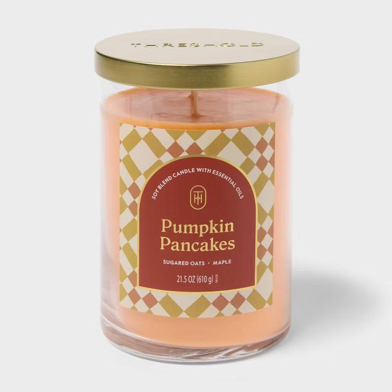 Candle labeled 'Pumpkin Pancakes' with cinnamon sticks and caramel pieces on a light background 21.5oz