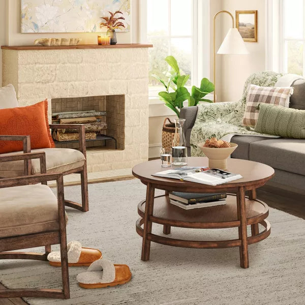 Living room with a fireplace, sofa, chairs, and a coffee table.