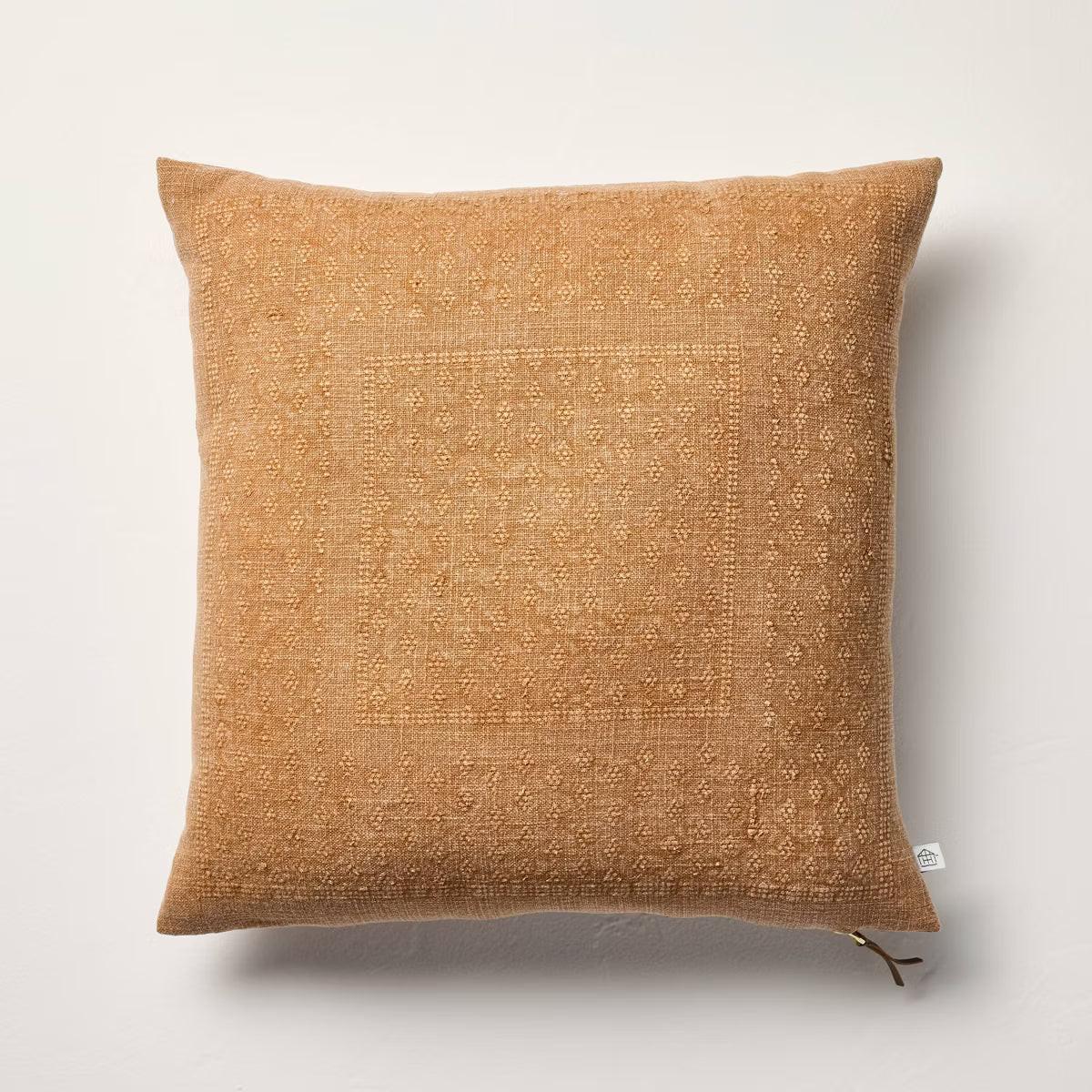 Brown textured pillow with a zipper on a light gray background Natural