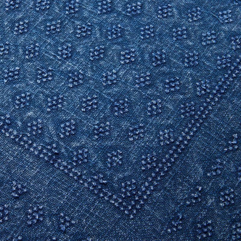 Blue textured pillow on a light gray background Navy