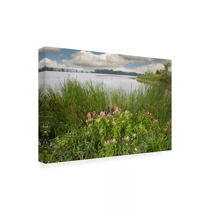Canvas print of a landscape with a lake, grass, and flowers on a white background