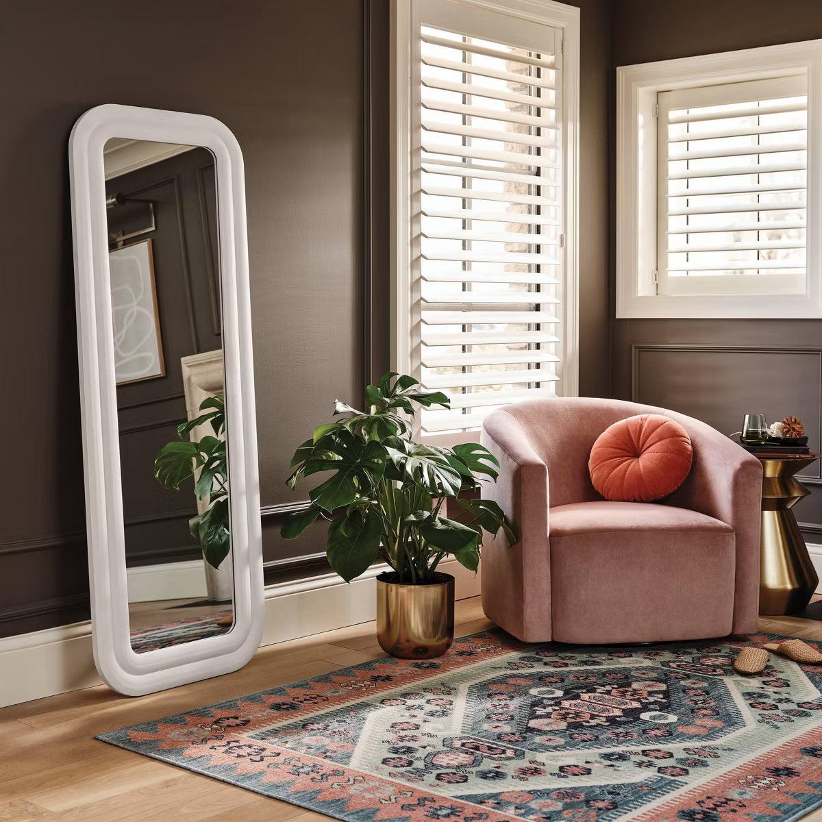A white colored mirror with a rounded rectangular frame against a light gray background.