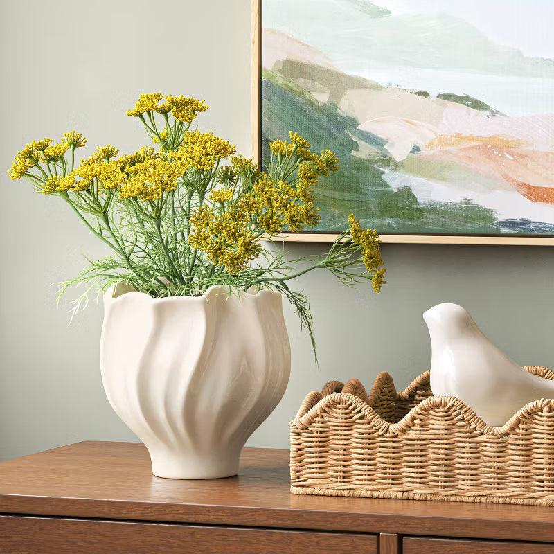 A white colored planter with a wavy, scalloped edge and smooth, glossy finish.