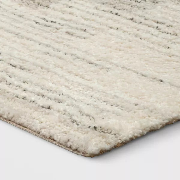 Close-up of a textured beige rug on a white background