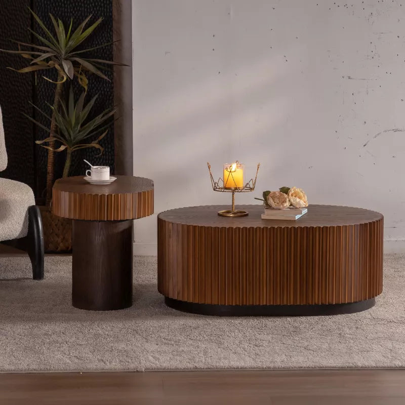 Wooden coffee table with a textured surface, featuring a book and flowers on top.