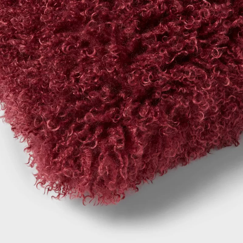 Fluffy red-brown cushion on a light gray background Berry Purple