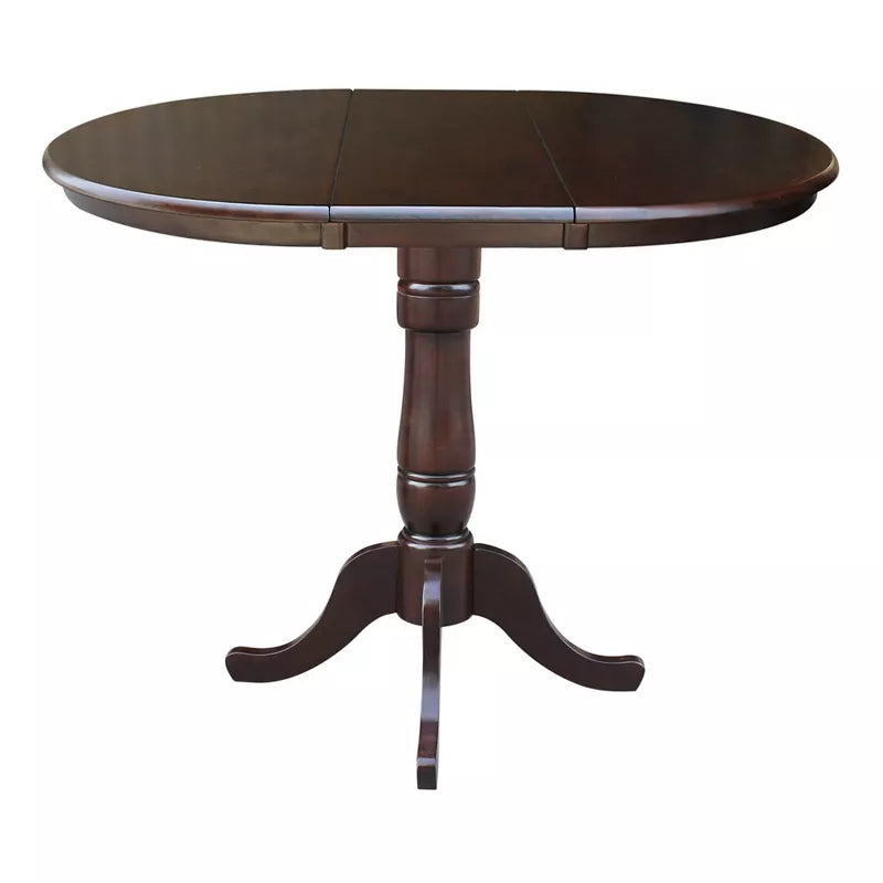 Round wooden dining table with a pedestal base on a white background