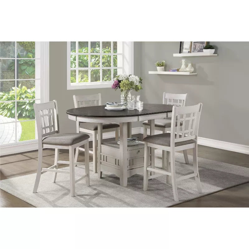 Dining room with a round table and four chairs in a home setting.