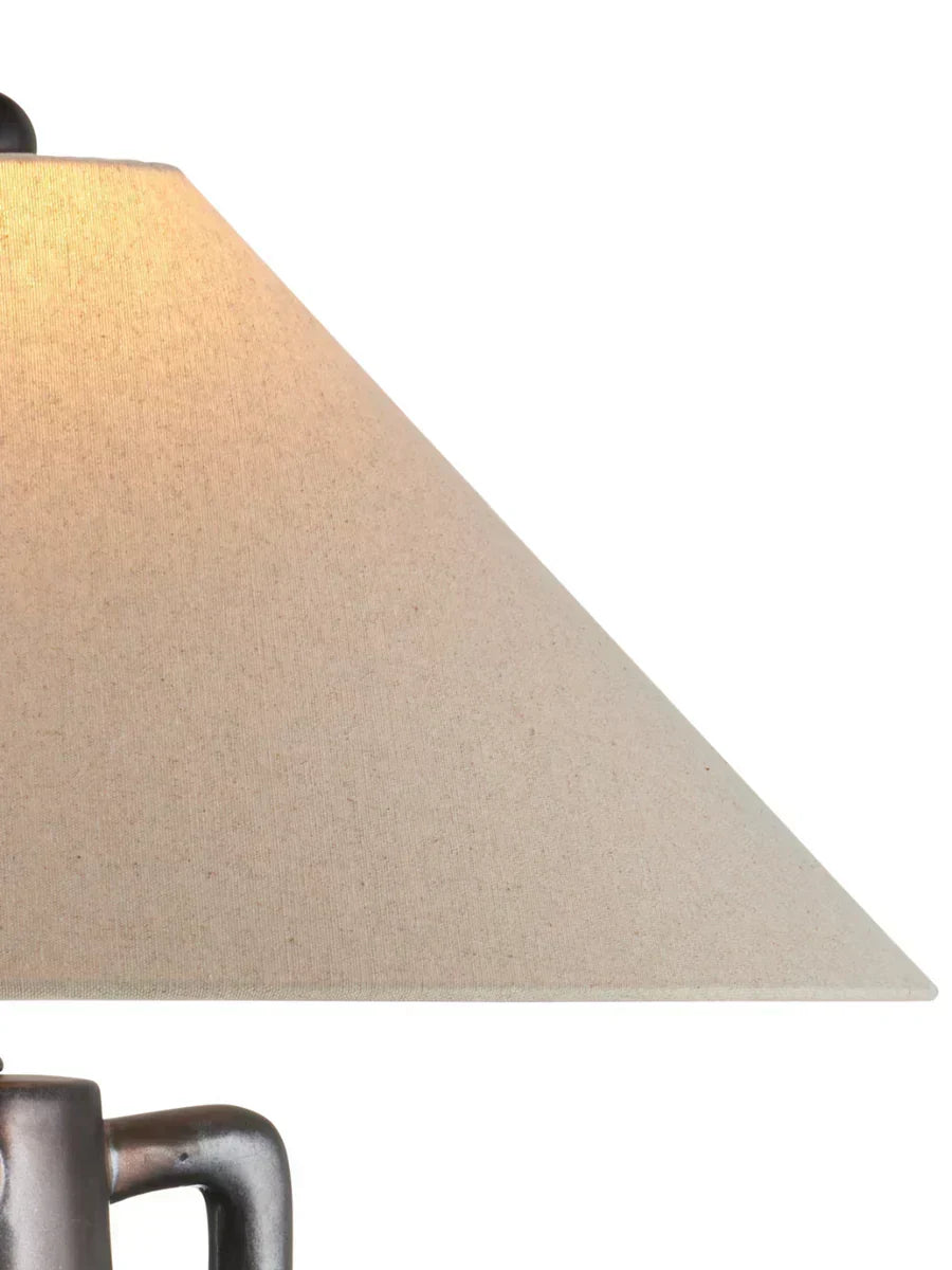 Jug-shaped gray ceramic table lamp with reactive glaze finish, bronze accents, and a classic empire shade.