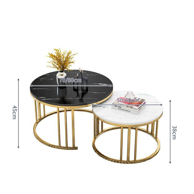 Two round coffee tables with gold frames on a patterned rug, with a sofa and decorative pillows in the background black White