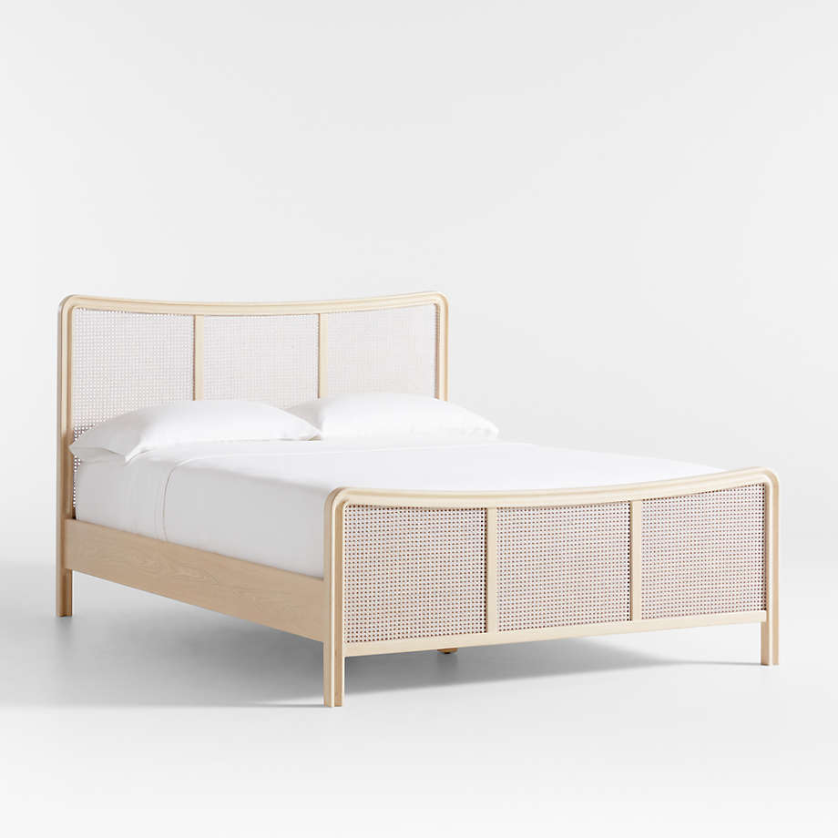 Bed with wooden frame and woven sides on a white background