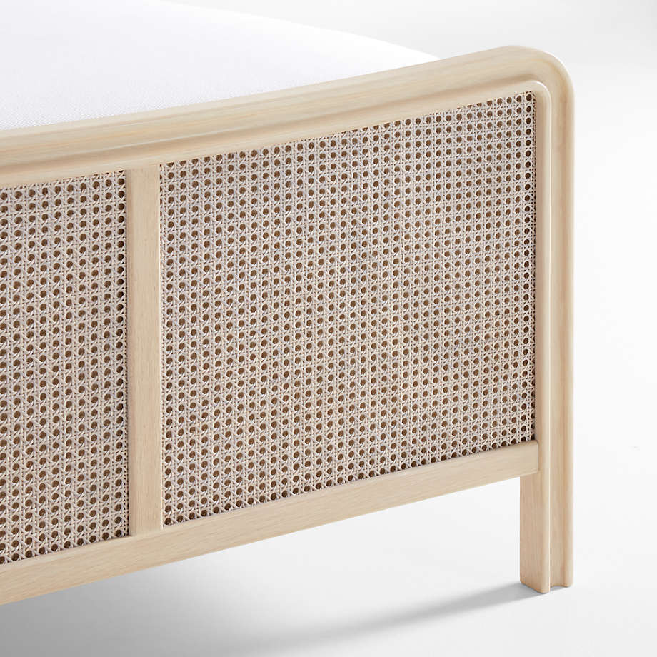 Wooden headboard with woven cane design on a white background