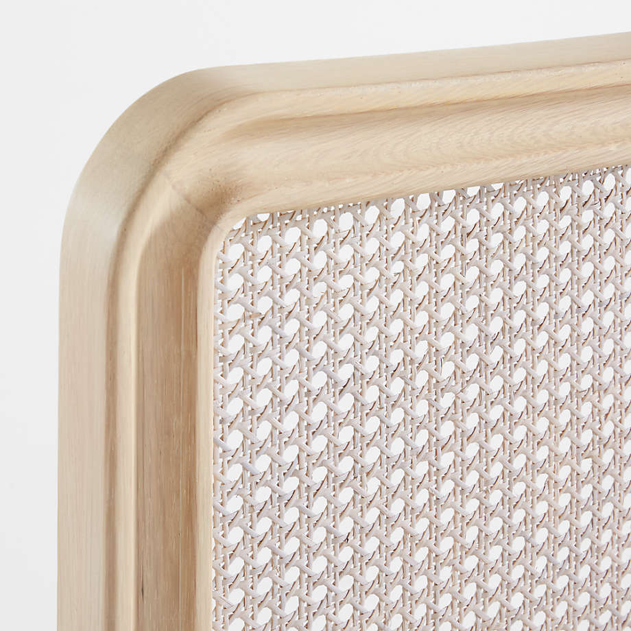 Close-up of a woven tray with a light wood border on a white background