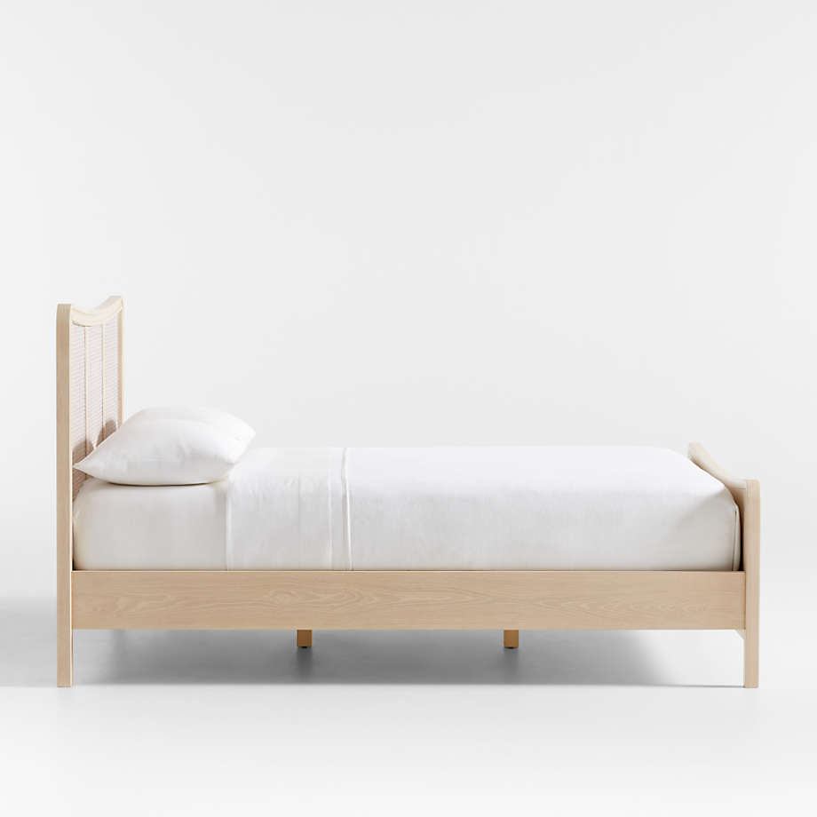 Wooden bed with white bedding on a white background
