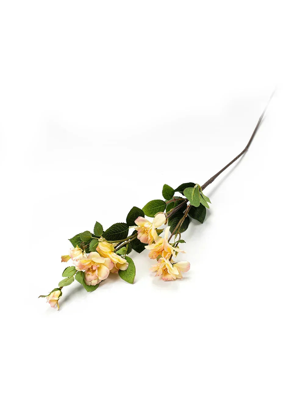 Artificial flower branch with green leaves and yellow flowers on a white background