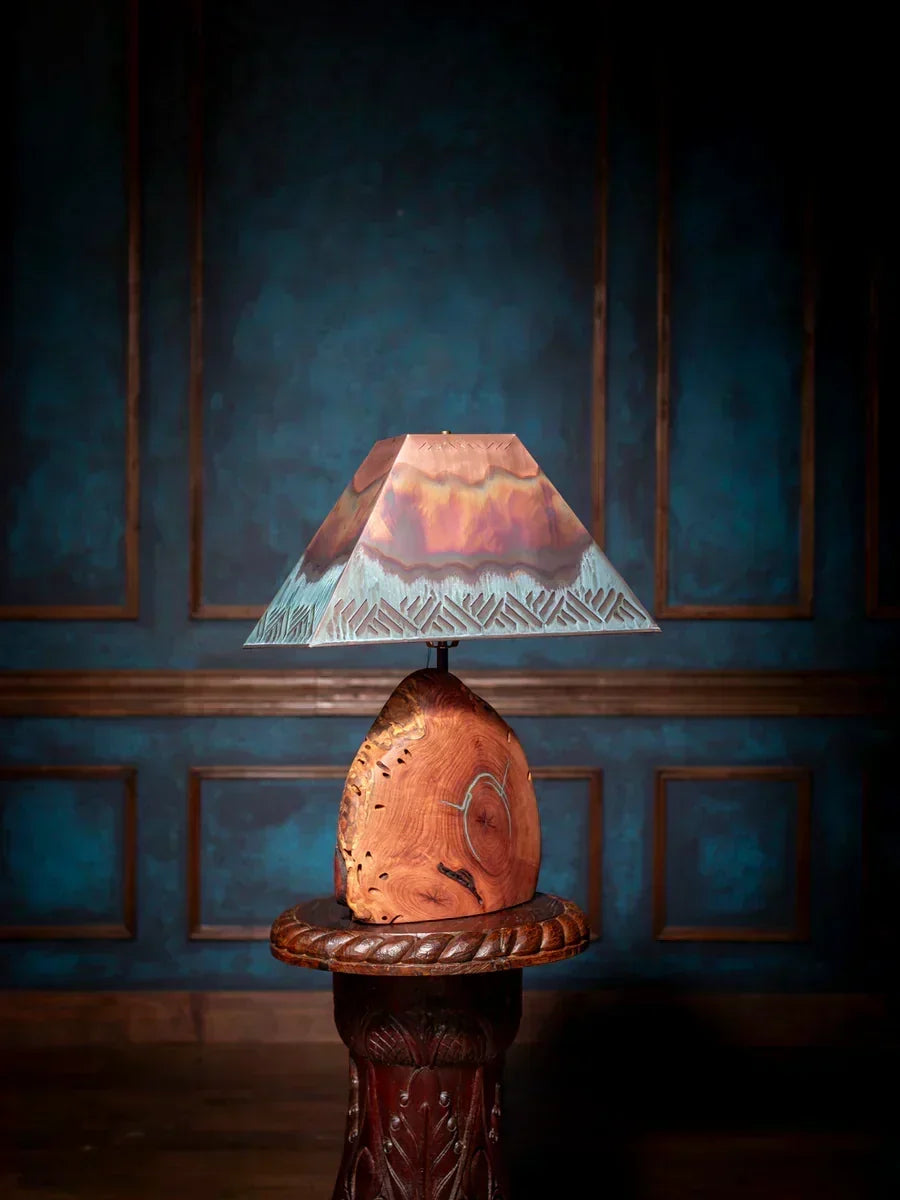 Mesquite table lamp with copper shade and turquoise inlay on a rustic wood base.