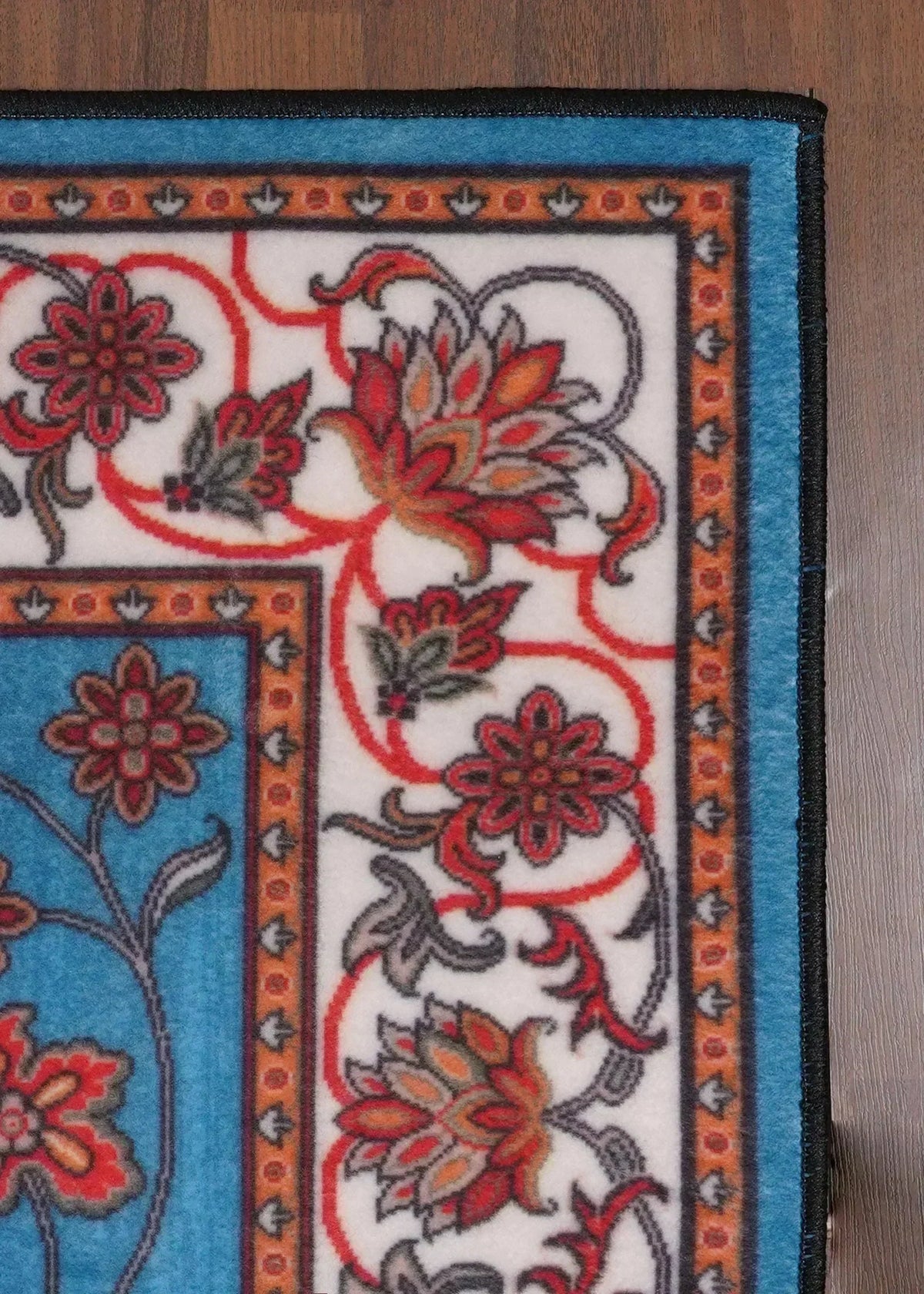 Decorative rug with floral patterns on a wooden floor