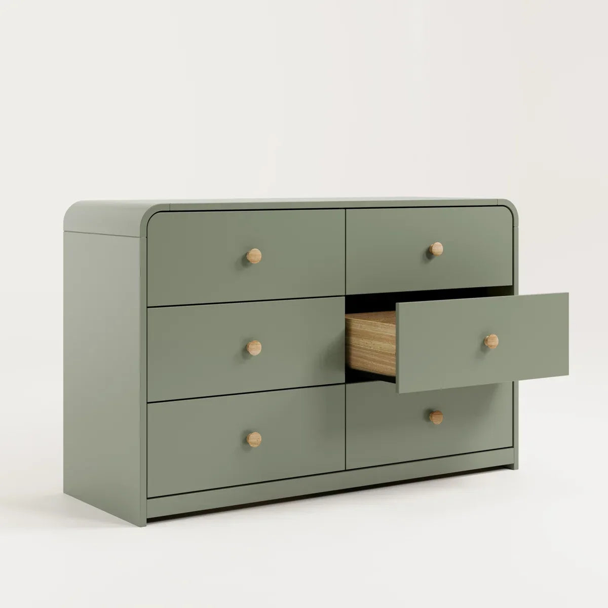 A modern six-drawer dresser in a muted sage green with small round light wood knobs, shown against a neutral beige background.