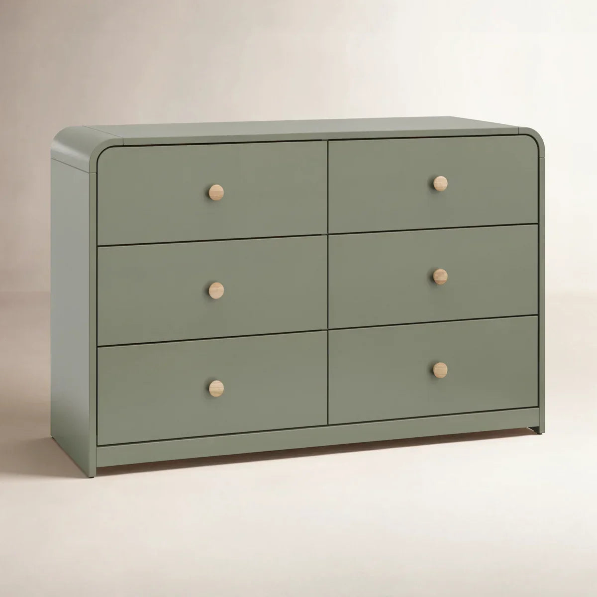A modern six-drawer dresser in a muted sage green with small round light wood knobs, shown against a neutral beige background.