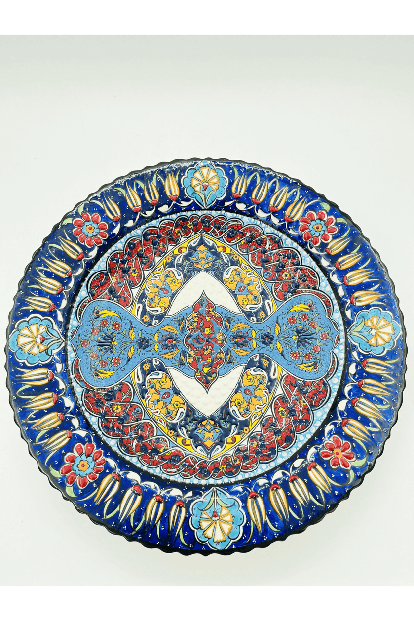 Decorative plate with intricate blue, red, and gold patterns on a white background
