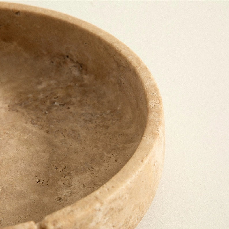 Beige ceramic bowl on a beige background