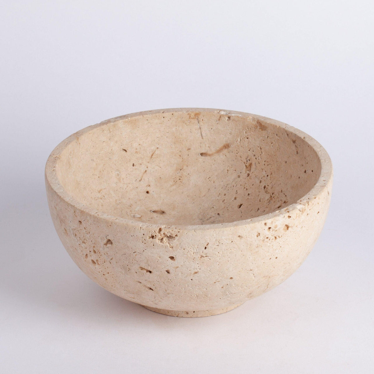 Beige ceramic bowl on a light gray background