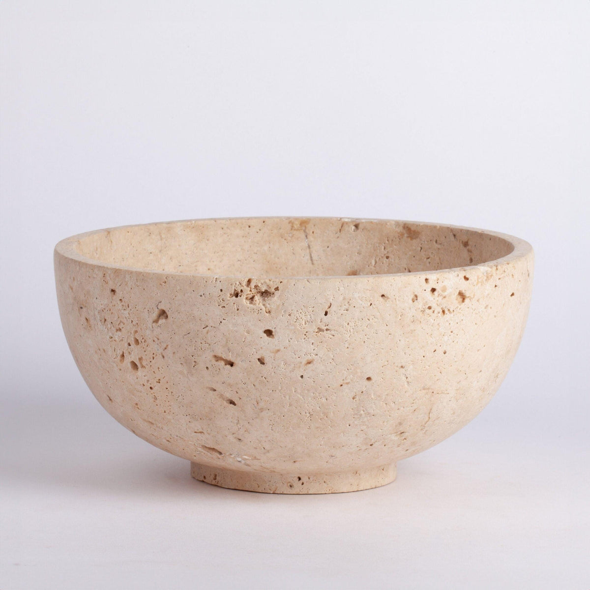 Beige ceramic bowl on a light gray background