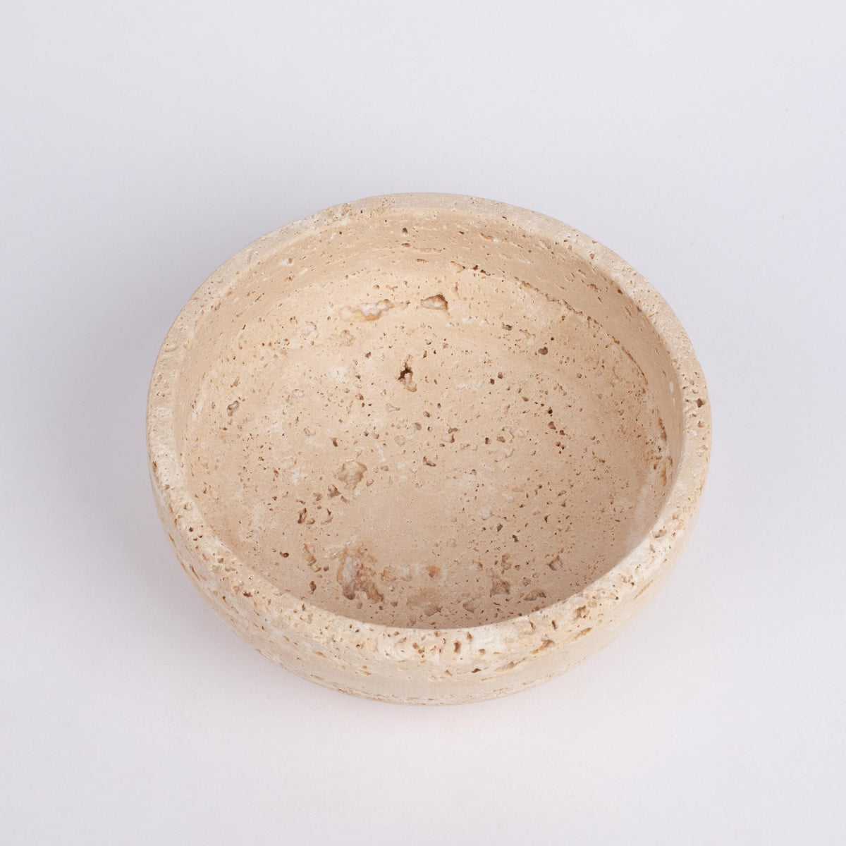 Beige stone bowl on a light gray background