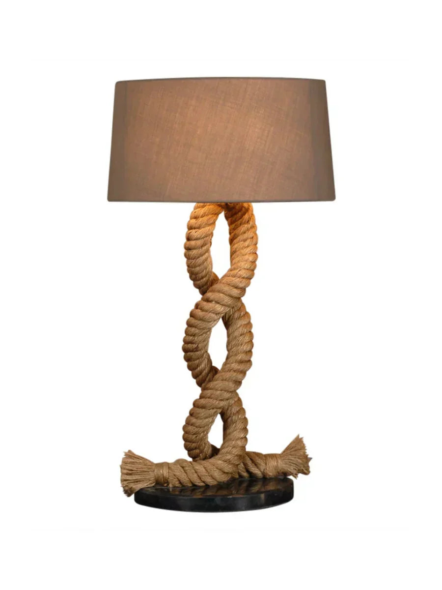 Rustic twisted rope table lamp with black marble base and neutral fabric shade.