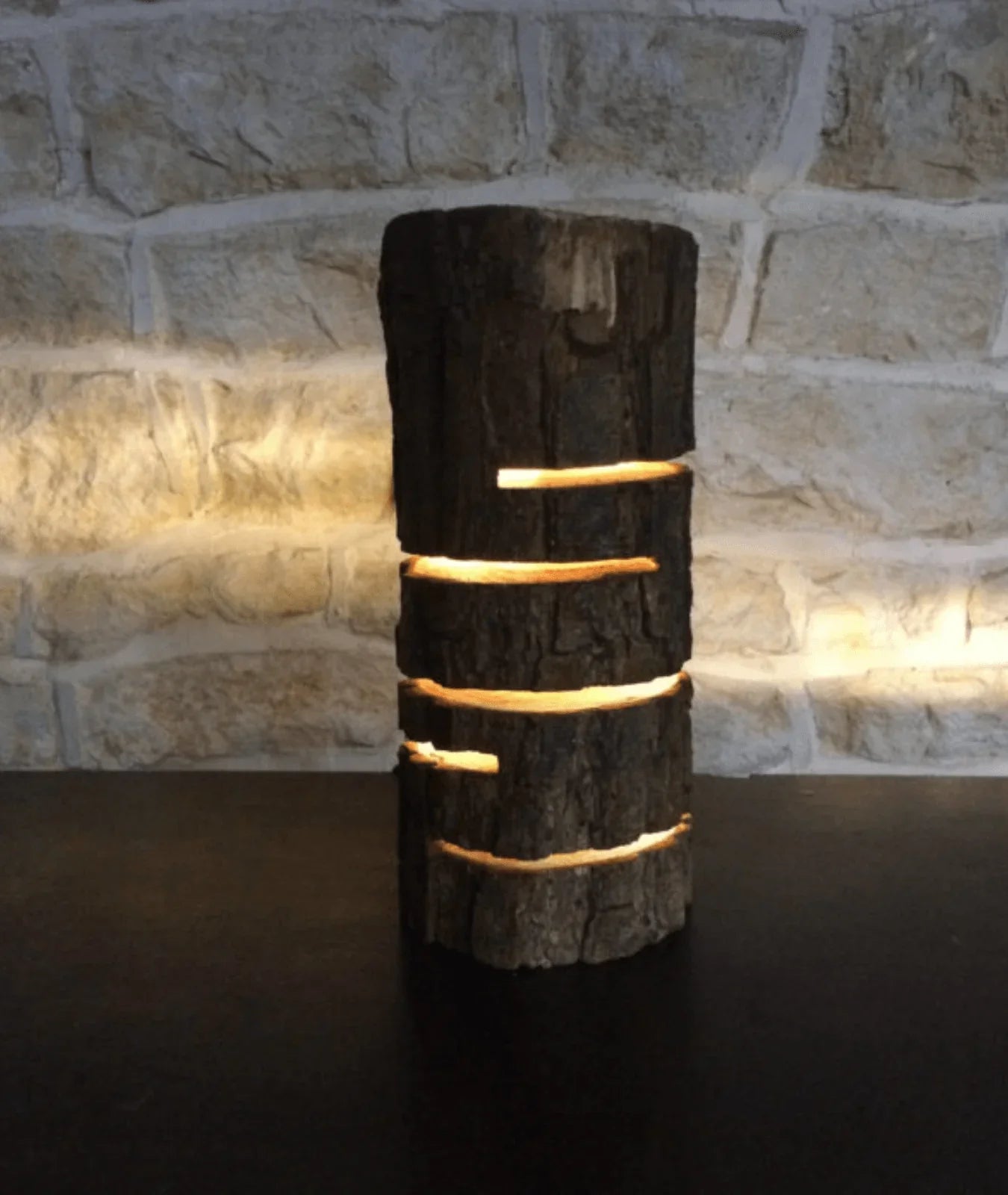 “Glowing Log Wooden Lamp with burnt edges and vertical glowing slits, handcrafted from natural wood with built-in LED for warm rustic ambiance.”