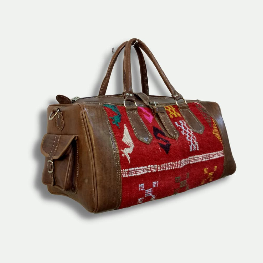 Brown leather bag with a colorful pattern on a light gray background