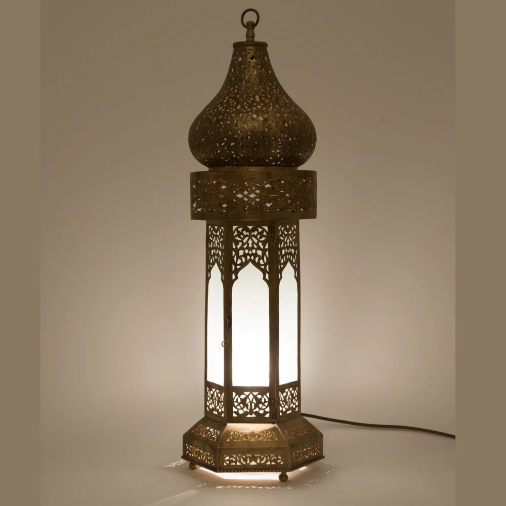 Decorative lamp with intricate cut-out design on a neutral background