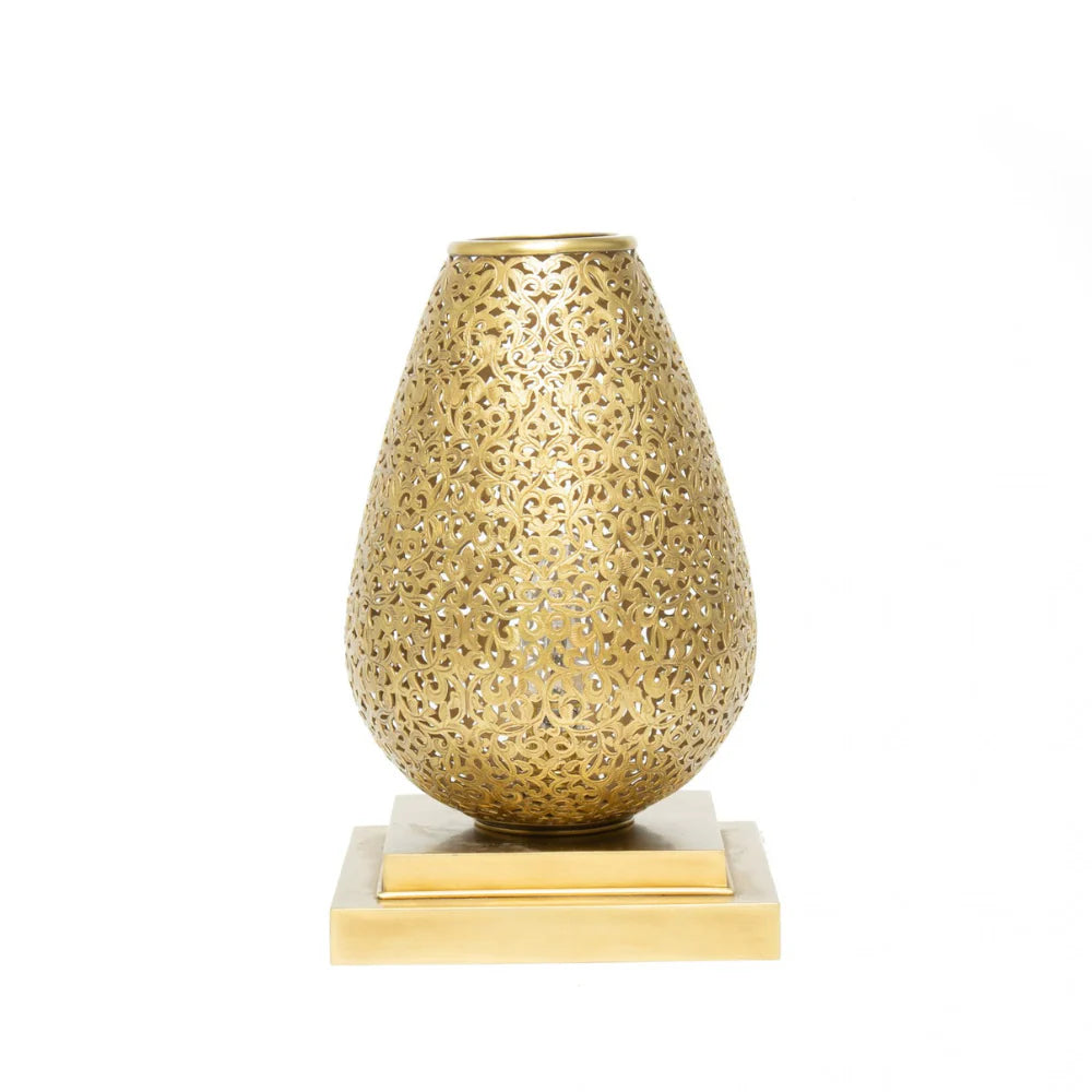 Decorative gold vase with intricate patterns on a white background