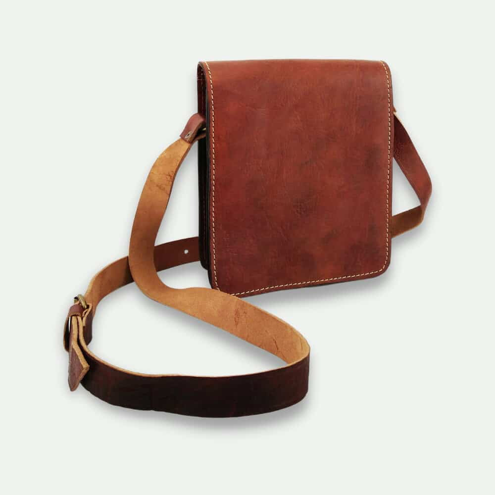Brown leather crossbody bag on a light gray background