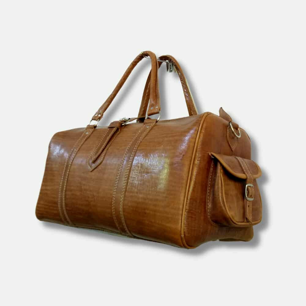 Brown leather duffel bag on a light beige background