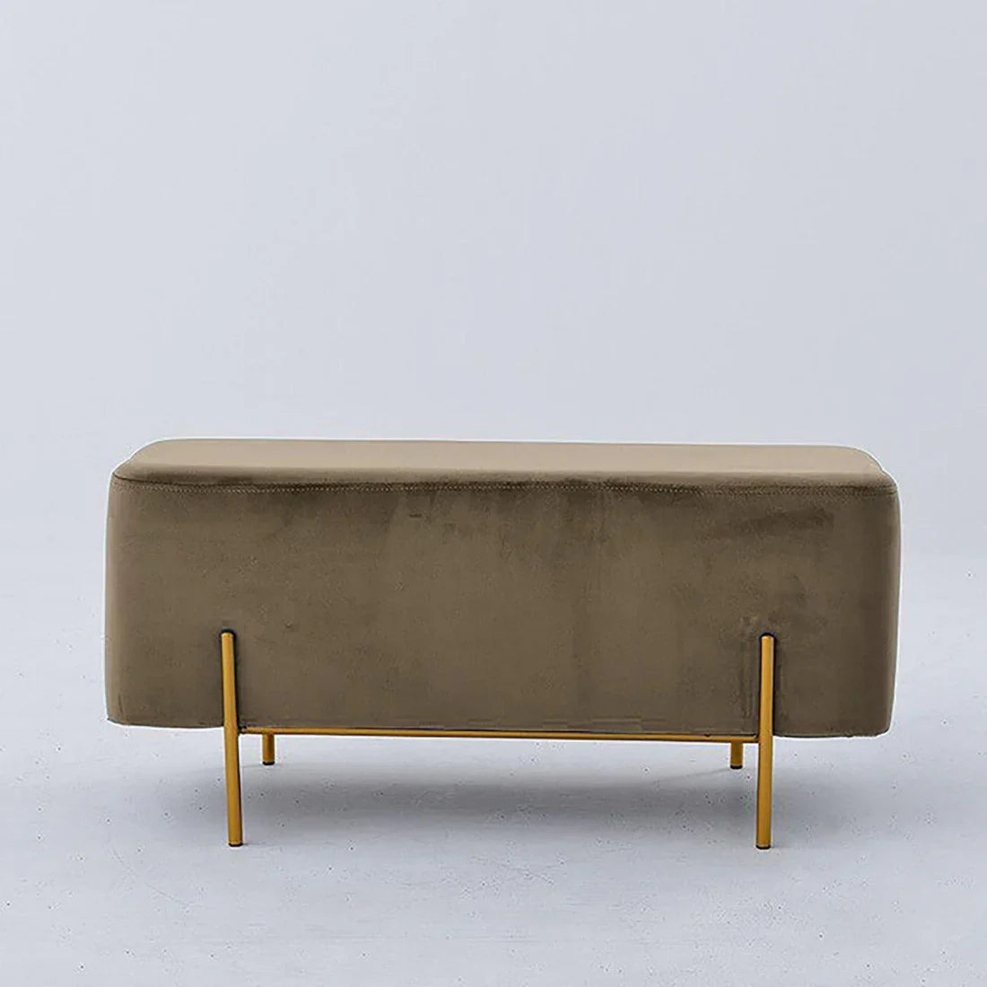 Beige upholstered bench with gold legs on a light gray background