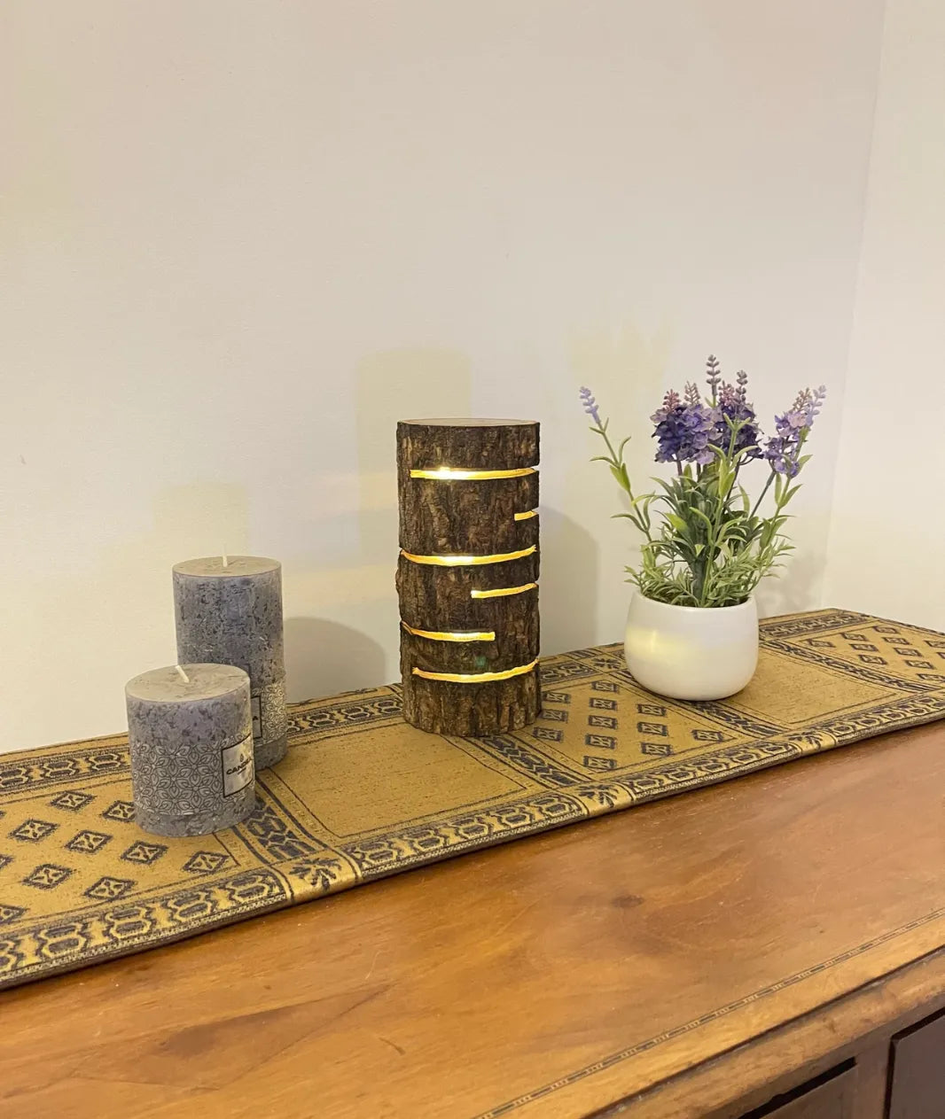 “Glowing Log Wooden Lamp with burnt edges and vertical glowing slits, handcrafted from natural wood with built-in LED for warm rustic ambiance.”