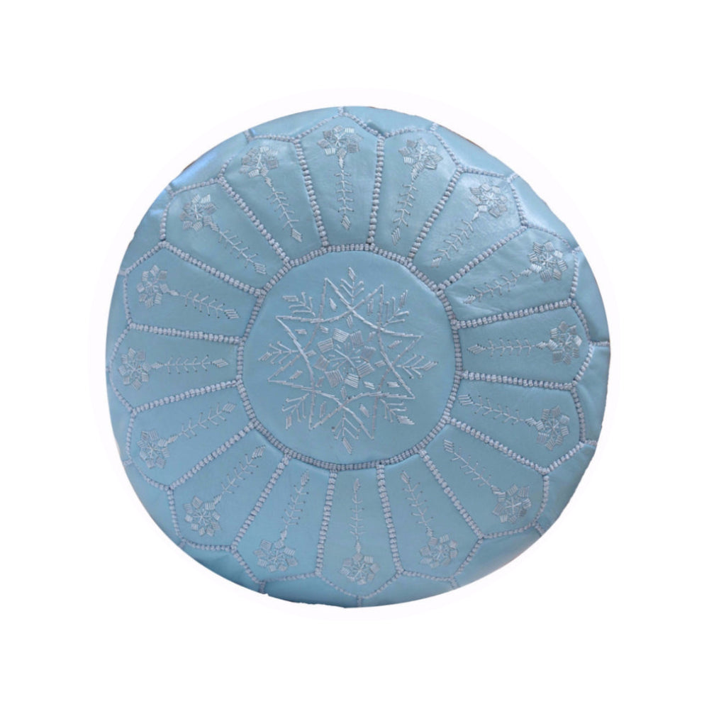Round blue cushion with floral patterns on a white background