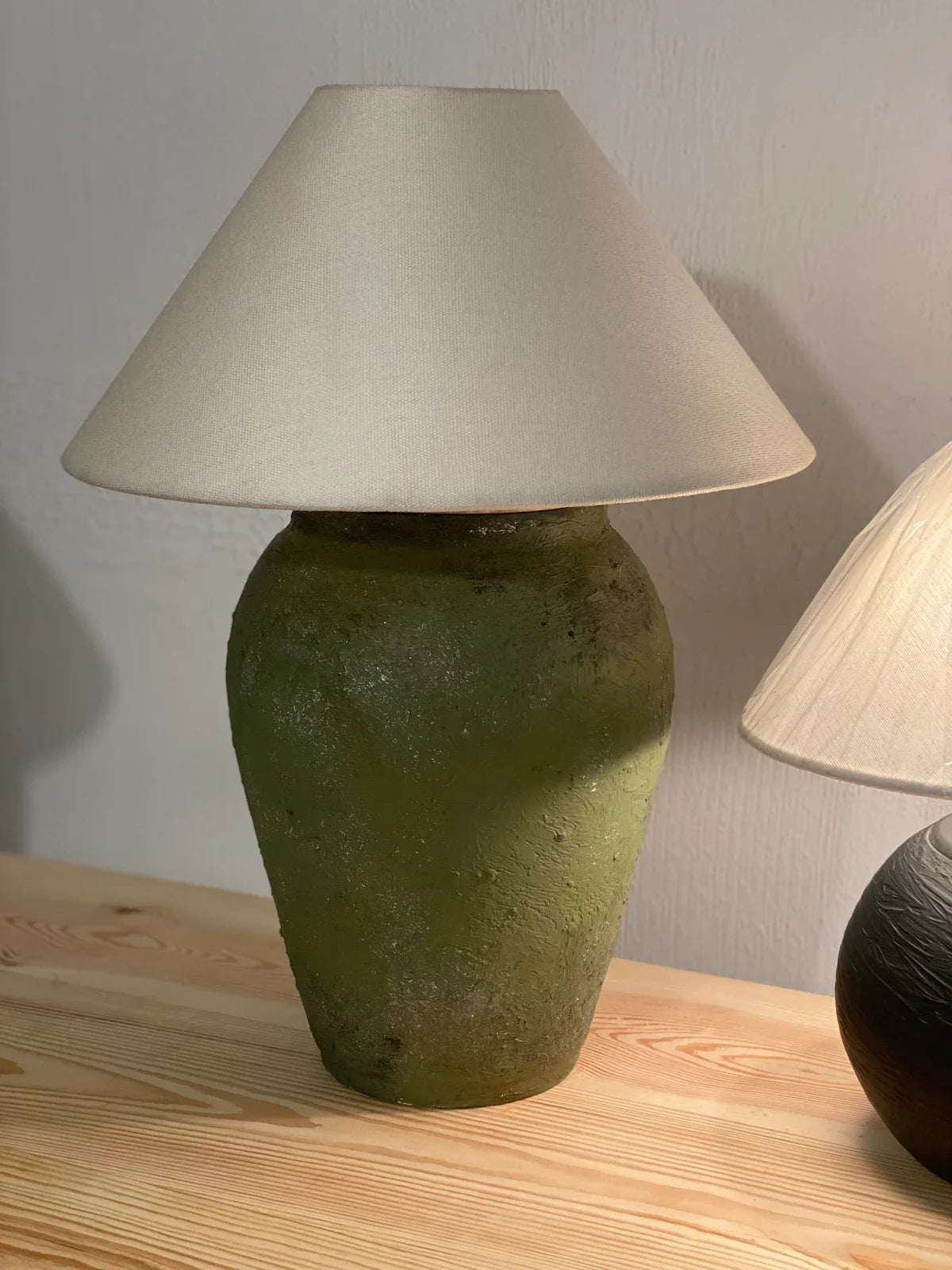 “Rustic olive green terracotta table lamp with handcrafted base and warm rust accents, paired with a wide shade – 24.8-inch artisan ceramic lighting.”